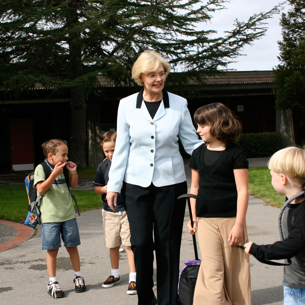 Pat with children at school